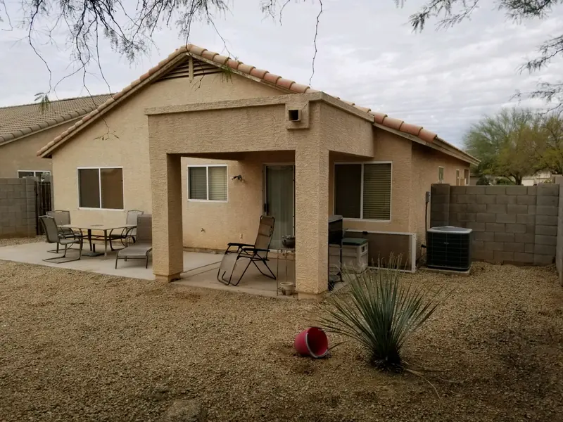 Backyard cleanup after: the weeds cleared and the gravel showing