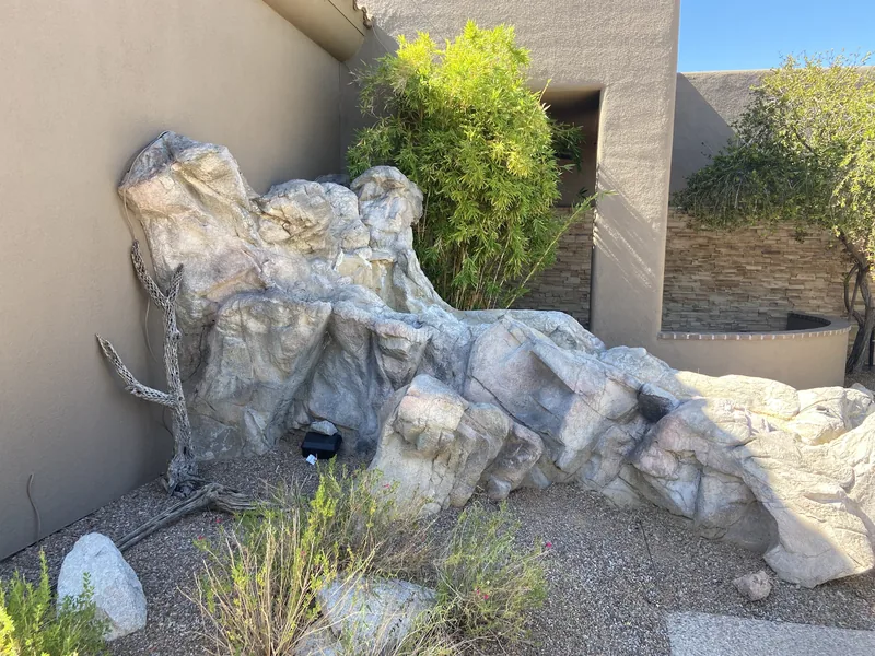 Concrete removal in Oro Valley, before: a faux rock water feature