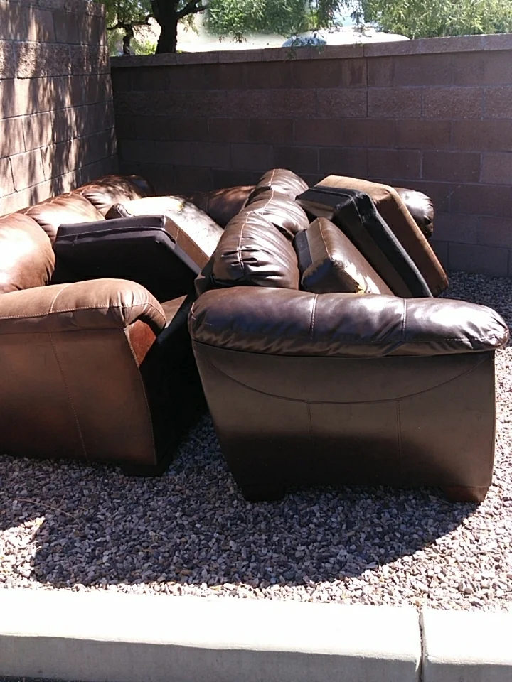 Couch removal in Tucson, before: leather couches and recliners by the curb