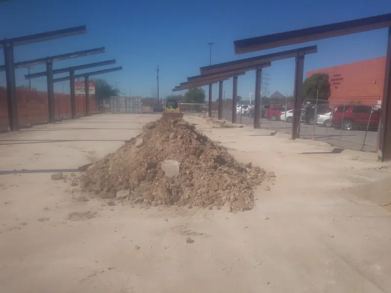 Dirt removal before: a pile of dirt and rock on a commercial lot