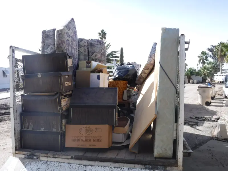 Haul off: a trailer loaded with dressers, cushions, mattresses and boxes