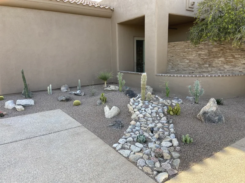 Rock and gravel installation in Oro Valley, after: new gravel and a dry river bed where the water feature was