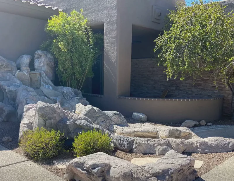 Rock and gravel installation in Oro Valley, before: an old faux rock water feature